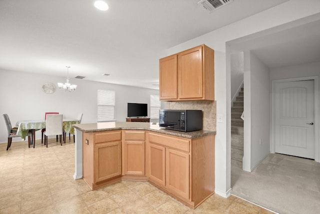 11104 Helms Deep Dr, Austin, TX 78754 - kitchen featuring black microwave, a chandelier, a peninsula, hanging light fixtures, and recessed lighting