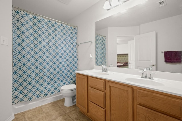 11104 Helms Deep Dr, Austin, TX 78754 - bathroom featuring double vanity and toilet
