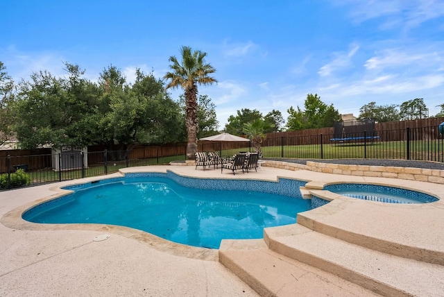 11606 Uplands Ridge Dr, Bee Cave, TX 78738 - view of swimming pool with a trampoline, an in-ground hot tub, and a fenced backyard