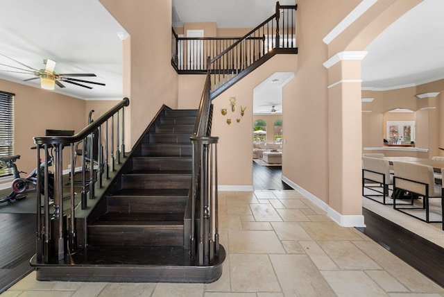 11606 Uplands Ridge Dr, Bee Cave, TX 78738 - stairway featuring a ceiling fan, arched walkways, ornamental molding, and ornate columns