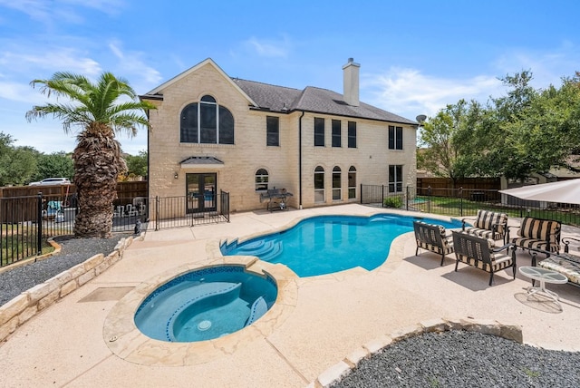 11606 Uplands Ridge Dr, Bee Cave, TX 78738 - view of pool featuring french doors, a patio area, a fenced backyard, and a pool with connected hot tub