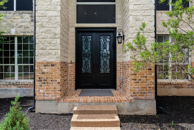 11606 Uplands Ridge Dr, Bee Cave, TX 78738 - view of exterior entry featuring french doors, brick siding, and stone siding