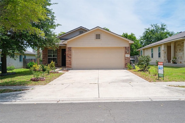 214 Wild Plum, San Marcos, TX 78666 - ranch-style home featuring brick siding, concrete driveway, a garage, and a front yard