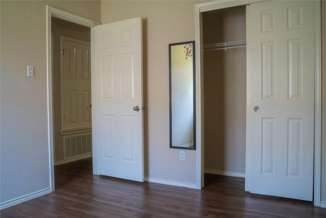 214 Wild Plum, San Marcos, TX 78666 - unfurnished bedroom featuring dark wood finished floors and a closet