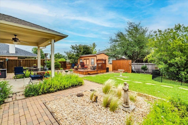 18717 Shoreless Dr, Pflugerville, TX 78660 - fenced backyard with a wooden deck, ceiling fan, and a patio area