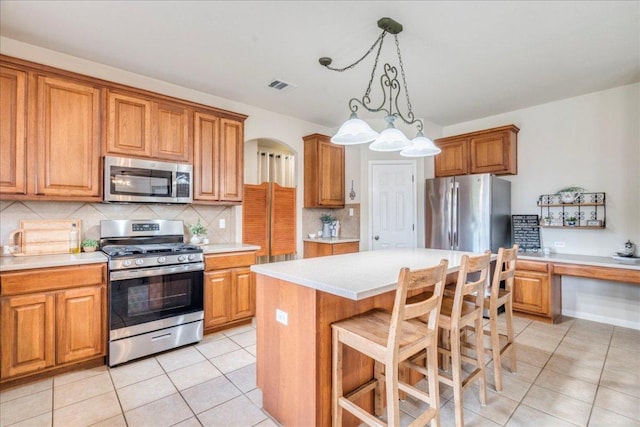 18717 Shoreless Dr, Pflugerville, TX 78660 - kitchen with appliances with stainless steel finishes and brown cabinets