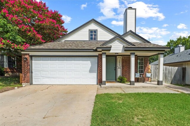 12922 Staton Dr, Austin, TX 78727 - view of front of home featuring brick siding, concrete driveway, a garage, covered porch, and a chimney