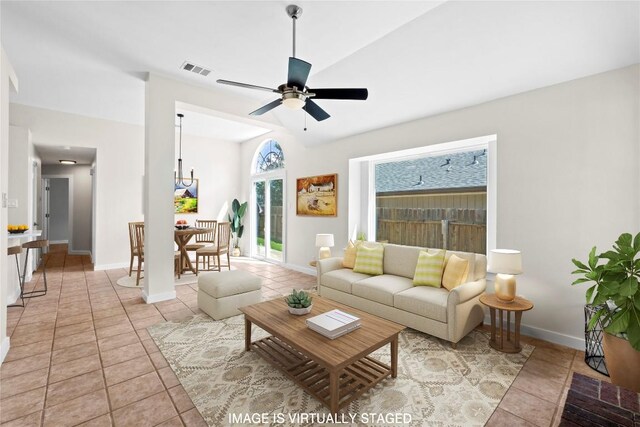 12922 Staton Dr, Austin, TX 78727 - living area featuring light tile patterned floors, ceiling fan, and vaulted ceiling