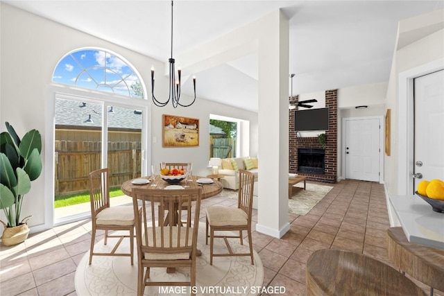 12922 Staton Dr, Austin, TX 78727 - dining space featuring a fireplace, light tile patterned floors, a ceiling fan, and vaulted ceiling