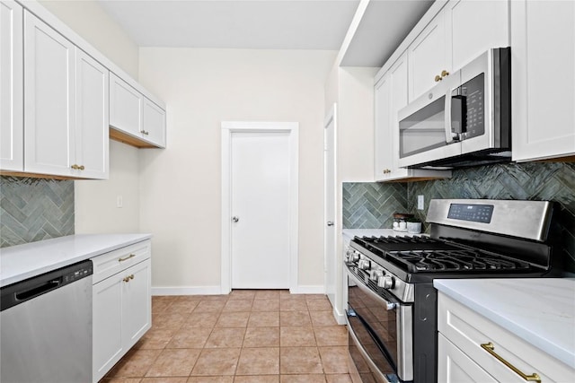 12922 Staton Dr, Austin, TX 78727 - kitchen with appliances with stainless steel finishes, backsplash, white cabinetry, and light tile patterned floors