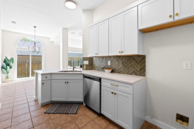 12922 Staton Dr, Austin, TX 78727 - kitchen with stainless steel dishwasher, a chandelier, tasteful backsplash, a peninsula, and light countertops