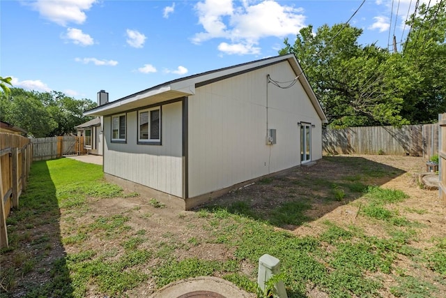 12922 Staton Dr, Austin, TX 78727 - view of home's exterior featuring a fenced backyard and a chimney