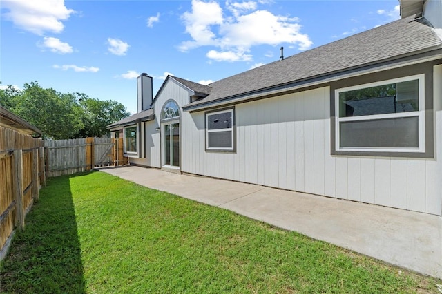 12922 Staton Dr, Austin, TX 78727 - back of house featuring a chimney, a fenced backyard, a patio area, and roof with shingles
