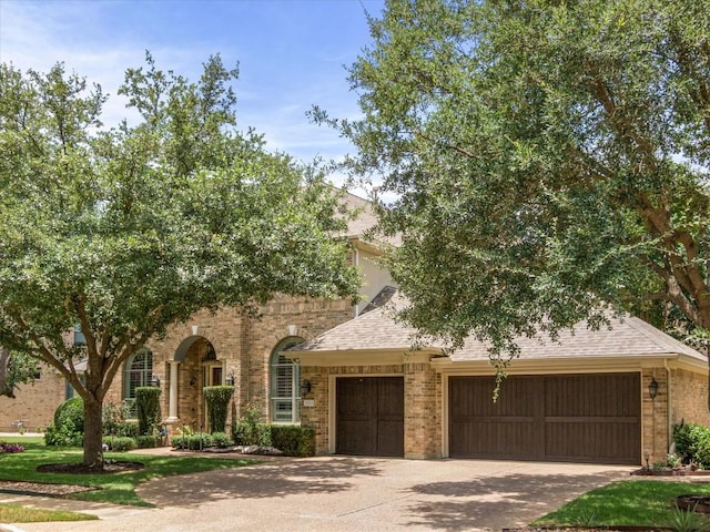 13212 Coleto Creek Trl, Austin, TX 78732 - view of front of property featuring brick siding, an attached garage, concrete driveway, and a shingled roof