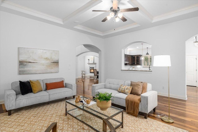 13212 Coleto Creek Trl, Austin, TX 78732 - living area with arched walkways, light wood-type flooring, coffered ceiling, ornamental molding, and ceiling fan