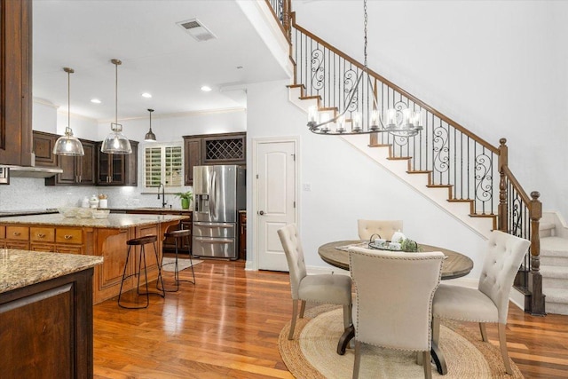 13212 Coleto Creek Trl, Austin, TX 78732 - dining room featuring stairs, light wood-style floors, and recessed lighting