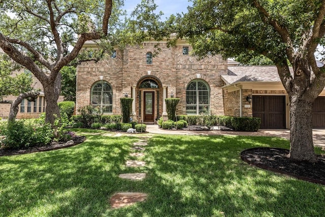 13212 Coleto Creek Trl, Austin, TX 78732 - view of front of house with brick siding, a front lawn, and a garage