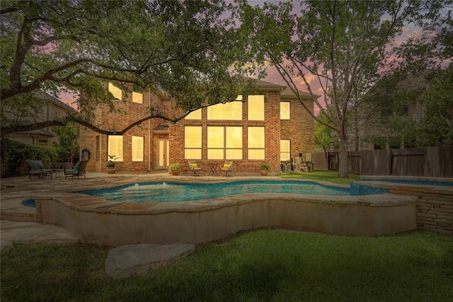 13212 Coleto Creek Trl, Austin, TX 78732 - pool at dusk with a fenced backyard and a patio area