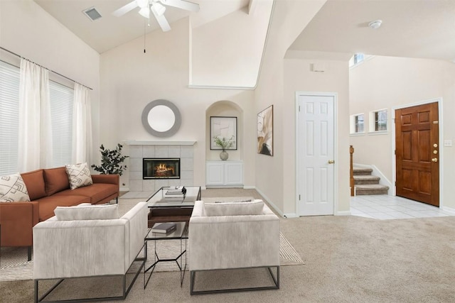 6710 Telluride Trl, Austin, TX 78749 - carpeted living area with high vaulted ceiling, ceiling fan, a tiled fireplace, and stairs