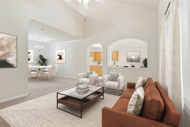 6710 Telluride Trl, Austin, TX 78749 - carpeted living area with arched walkways, a ceiling fan, a chandelier, and a towering ceiling