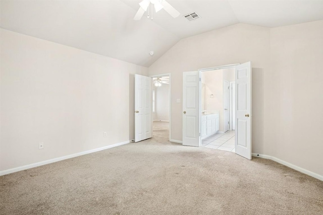 6710 Telluride Trl, Austin, TX 78749 - unfurnished bedroom featuring light colored carpet, lofted ceiling, ensuite bathroom, and ceiling fan