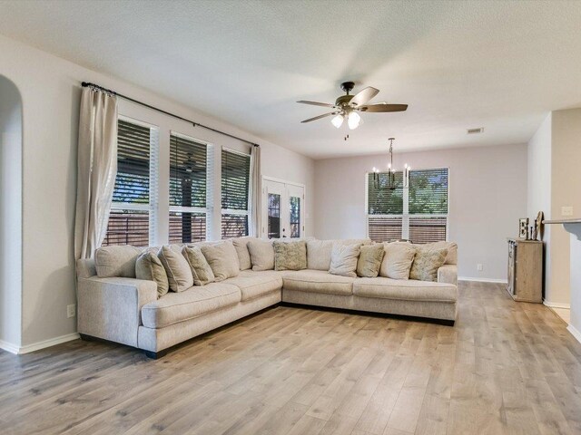 241 Sunnyside Dr, Kyle, TX 78640 - living area with ceiling fan, light wood-type flooring, and a chandelier