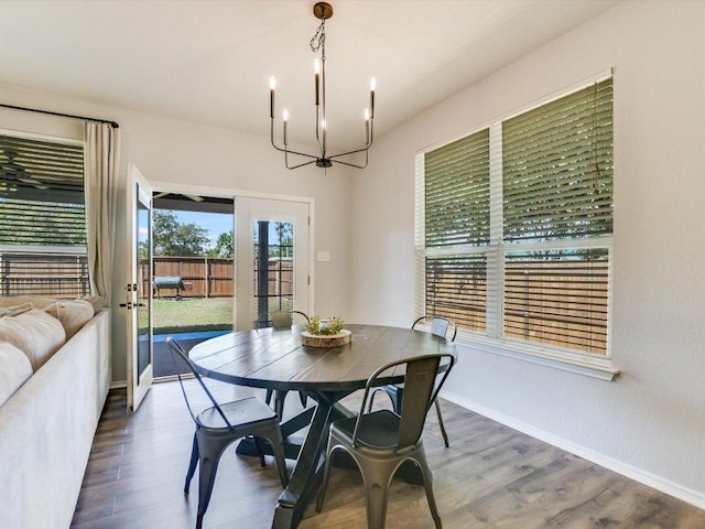 241 Sunnyside Dr, Kyle, TX 78640 - dining space with french doors, a chandelier, and wood finished floors