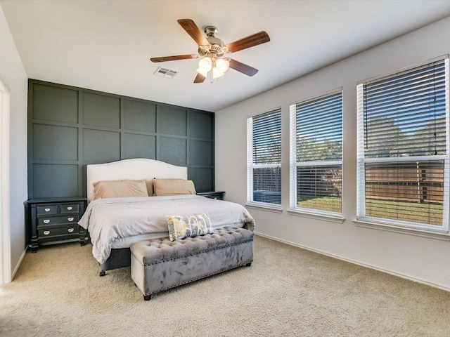 241 Sunnyside Dr, Kyle, TX 78640 - bedroom with light carpet, a decorative wall, and ceiling fan