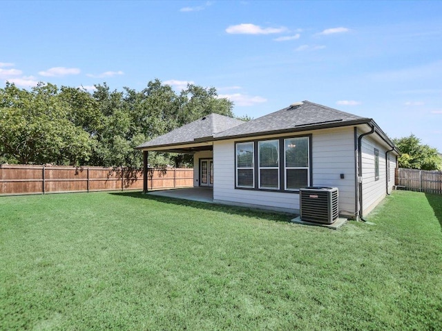 241 Sunnyside Dr, Kyle, TX 78640 - rear view of house with a fenced backyard, a shingled roof, and a patio