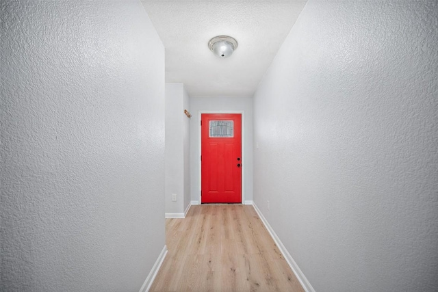 1009 Laurelleaf Dr, Pflugerville, TX 78660 - doorway to outside with light wood-style flooring and a textured wall