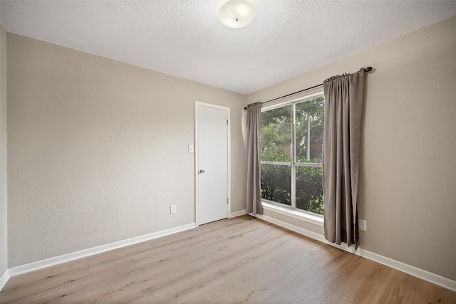 1009 Laurelleaf Dr, Pflugerville, TX 78660 - spare room featuring light wood-type flooring and a textured ceiling