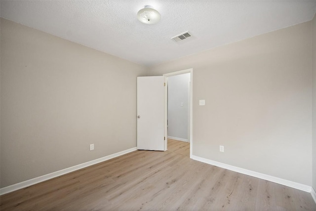 1009 Laurelleaf Dr, Pflugerville, TX 78660 - empty room featuring wood finished floors and a textured ceiling
