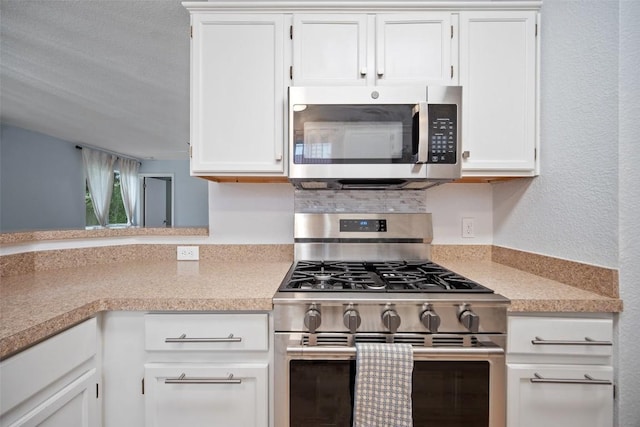 1009 Laurelleaf Dr, Pflugerville, TX 78660 - kitchen featuring stainless steel appliances, light countertops, and white cabinets