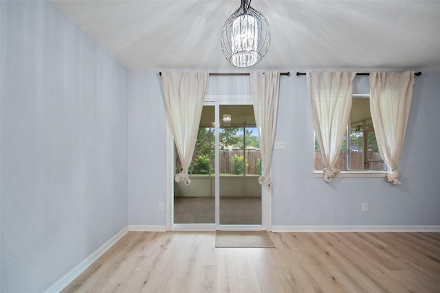 1009 Laurelleaf Dr, Pflugerville, TX 78660 - unfurnished dining area featuring wood finished floors and a chandelier