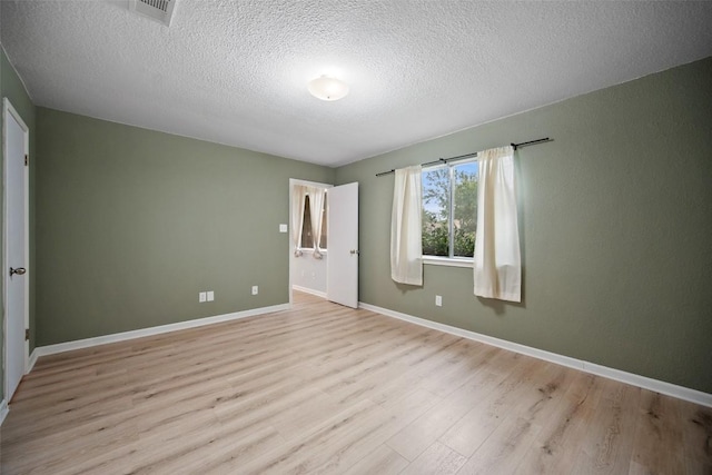 1009 Laurelleaf Dr, Pflugerville, TX 78660 - unfurnished bedroom featuring wood finished floors and a textured ceiling