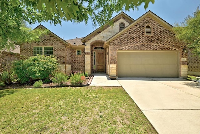 20024 Abigail Way, Pflugerville, TX 78660 - view of front facade featuring a garage, brick siding, driveway, and a front yard