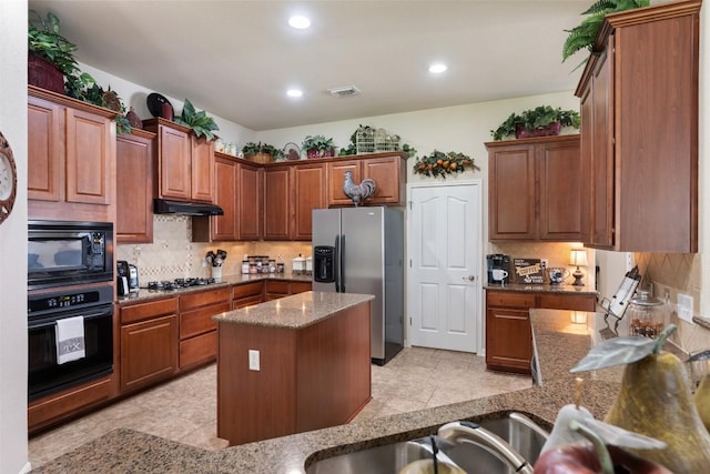 3509 Twin Branch Dr, Cedar Park, TX 78613 - kitchen featuring black appliances, tasteful backsplash, dark stone counters, under cabinet range hood, and recessed lighting