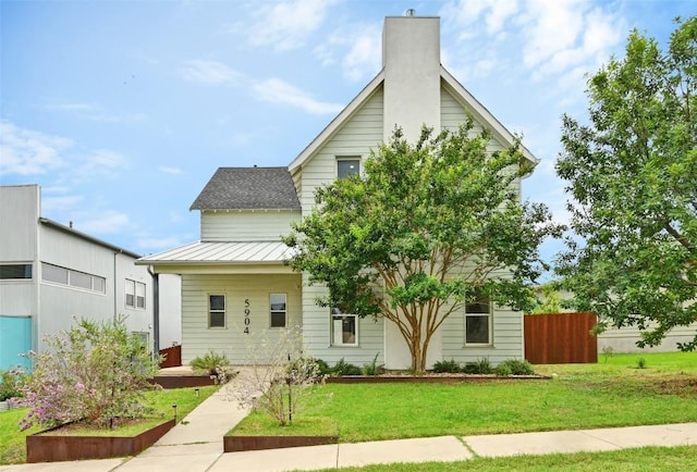 5904 Florencia Ln, Austin, TX 78724 - view of front facade featuring a standing seam roof, a metal roof, and a chimney