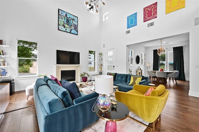 5904 Florencia Ln, Austin, TX 78724 - living area with a chandelier, wood-type flooring, and a high ceiling