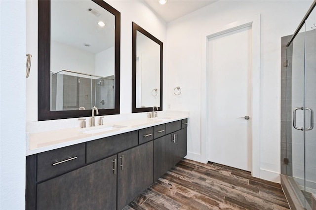 5904 Florencia Ln, Austin, TX 78724 - full bath with wood finished floors, a stall shower, double vanity, and recessed lighting