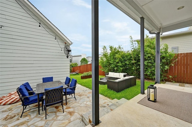 5904 Florencia Ln, Austin, TX 78724 - fenced backyard featuring an outdoor hangout area, outdoor dining area, and a patio
