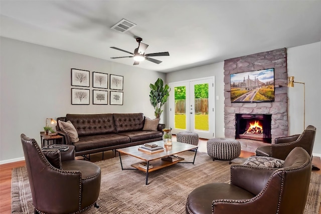 606 Elderberry Cv, Austin, TX 78745 - living room with wood finished floors, ceiling fan, and a fireplace