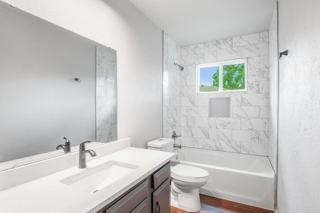 606 Elderberry Cv, Austin, TX 78745 - full bathroom with vanity, bathing tub / shower combination, wood finished floors, and a textured wall