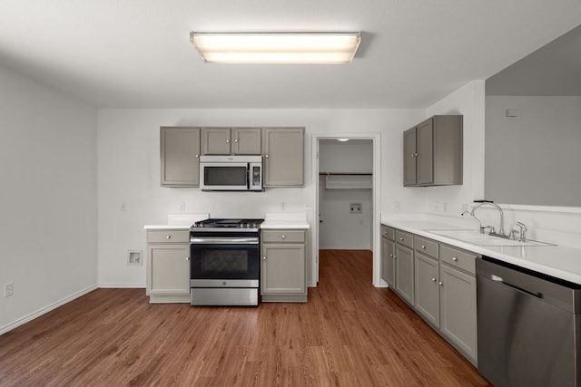 707 Eaglecreek Dr, Leander, TX 78641 - kitchen with appliances with stainless steel finishes, gray cabinets, and wood finished floors