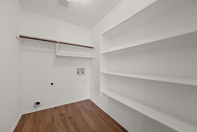 707 Eaglecreek Dr, Leander, TX 78641 - laundry room featuring hookup for an electric dryer, hookup for a washing machine, and wood finished floors