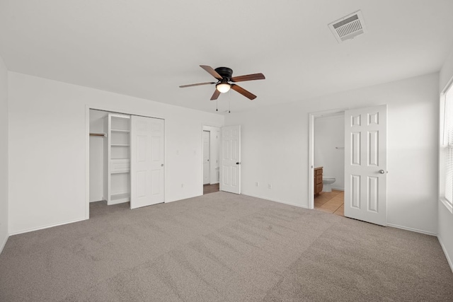 707 Eaglecreek Dr, Leander, TX 78641 - unfurnished bedroom featuring carpet, ensuite bath, a ceiling fan, and a closet
