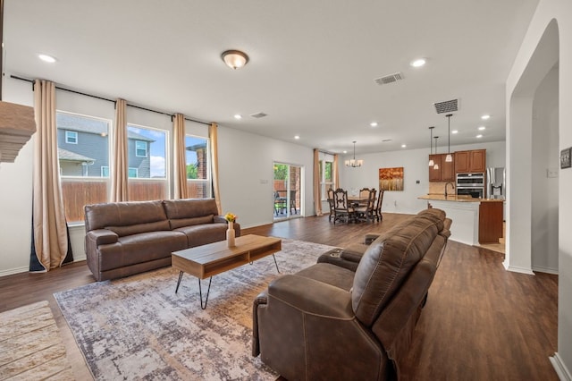 716 Madalin Rue Ct, Leander, TX 78641 - living room with dark wood-style flooring, recessed lighting, and arched walkways