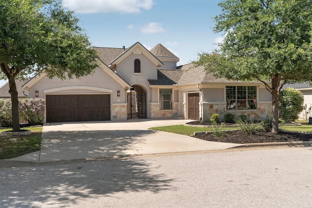 2105 Peoria Dr, Leander, TX 78641 - french provincial home with stone siding, a garage, stucco siding, and concrete driveway