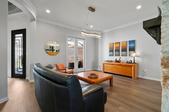2105 Peoria Dr, Leander, TX 78641 - living room featuring french doors, wood finished floors, healthy amount of natural light, crown molding, and recessed lighting