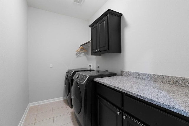 2105 Peoria Dr, Leander, TX 78641 - laundry area with cabinet space, separate washer and dryer, and light tile patterned flooring